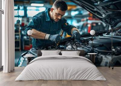 Car mechanic working in auto repair service. Closeup of auto mechanic hands repairing car engine Wall mural