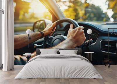 Close up of male hands on steering wheel of a car driving on the road Wall mural