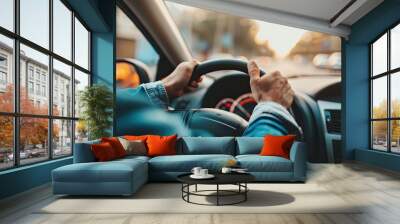 Close up of male hands on steering wheel of a car driving on the road Wall mural