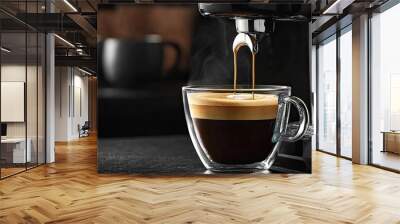 coffee machine is pouring espresso into a glass cup with beautiful foam on a dark background Wall mural