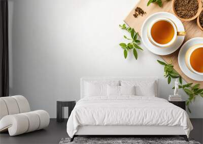 Green tea in a white teapot and cups on white background top view with copy space Wall mural