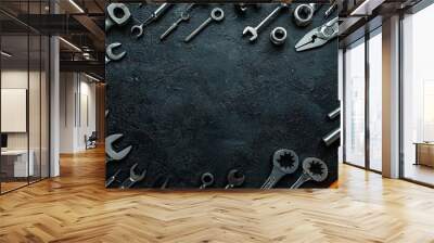 Spanners and tools on dark black background. Top view with copy space Wall mural