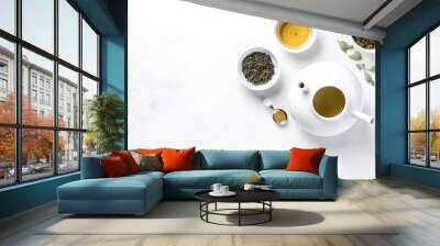 Top view mockup of teacups with teapot, organic green tea leaves and dried herbs on white table with copy space Wall mural