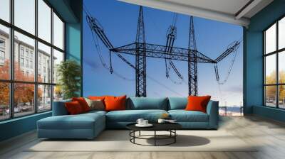 High voltage electric pole and transmission lines in the evening. Electricity pylons at sunset. Power and energy. Energy conservation. High voltage grid tower with wire cable at distribution station. Wall mural