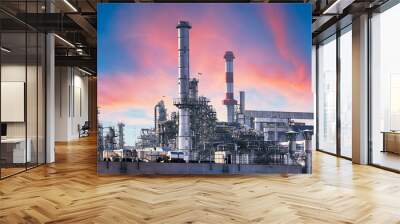 Pipeline and pipe rack of petroleum industrial plant with sunset sky background Wall mural