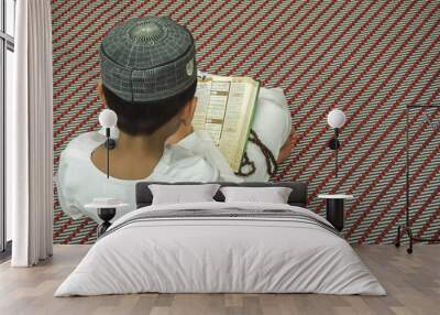 Boy reading Quran. Wall mural