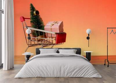 NEW YEAR CONCEPTUAL with shopping trolley,gift boxes and Christmas tree on a wooden table. Wall mural