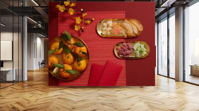 Chinese lunar new year with mandarin orange candy jam , fried potato , flower and ang pao biscuit in golden dish red background , photography Tet holiday content , top view Wall mural