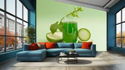 Front view of a glass of juice with fresh winter melon slices and leaf decorated on a light green background. Drinking winter melon tea regularly helps cool the body very well on hot days. Wall mural