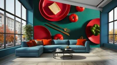 oposite color photo. Setting table with red dish and gold utensils. Wall mural