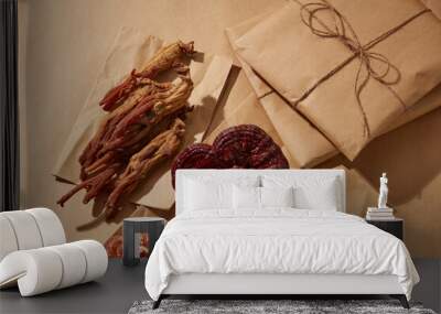 Red ginseng and Ganoderma lucidum against a background of golden paper. two exotic Eastern ingredients Wall mural