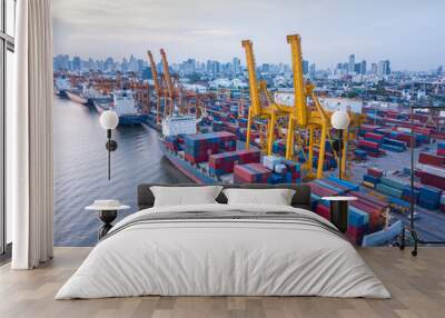 Aerial view of container ship loading containers by working crane in port terminal with container shipyard and imports exports logistics background Wall mural