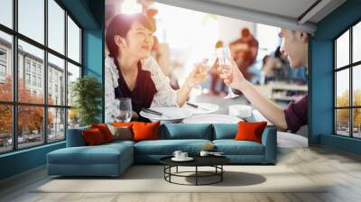 Asian young couple enjoying a romantic dinner  evening drinks while sitting at the dinning table on the kitchen together Wall mural