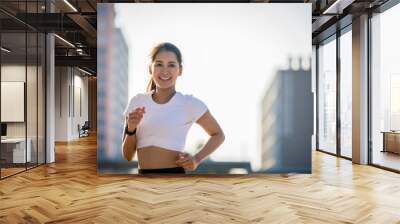 Asian Young fitness sport woman running  and smiling on city road Wall mural