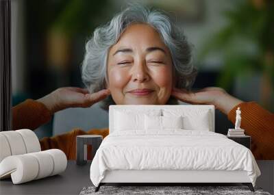 Cheerful senior woman stretching and doing exercises while watching a fitness video on her laptop in a cozy minimalist style living room at home  Concept of active aging Wall mural