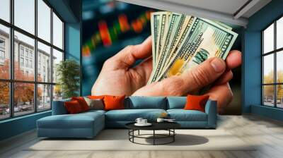 Hands Holding Dollar Bills with Financial Charts and Graphs in the Background Representing Wealth Investment and Economic Growth Wall mural