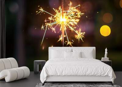 hand holding lit sparkler cracker diwali festival celebration with bright sparks flying off lights background festive atmosphere hindu culture Wall mural