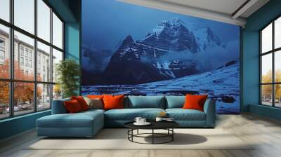 Snowy kailash parvat mountain peaks rise into dramatic blue sky Wall mural