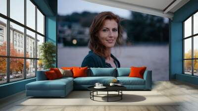 Germany, Hamburg, portrait of smiling redheaded woman Wall mural