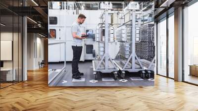 Man using tablet in factory shop floor Wall mural