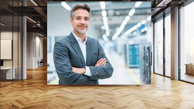 Portrait of a confident businessman in a modern factory Wall mural