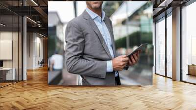 Portrait of confident businessman with tablet Wall mural