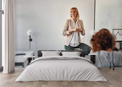 Pregnant woman leading a workshop in office Wall mural