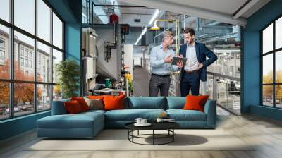 Two businessmen with tablet talking in a modern factory Wall mural