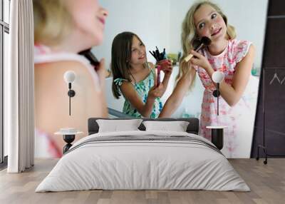 Two girls applying make up in bathroom Wall mural