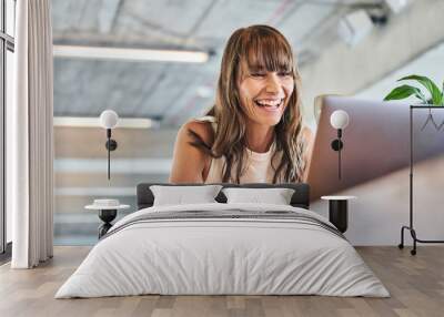 Woman smiling while using laptop at home Wall mural