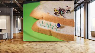 Photo close up top view Miniature Figure Farmer toy working  at Bread Wall mural