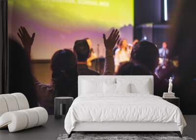 Hands in the air of a woman who praise God at church service Wall mural