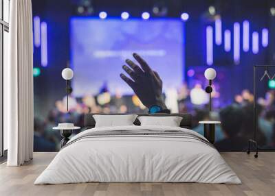 Hands in the air of people who praise God at church service Wall mural