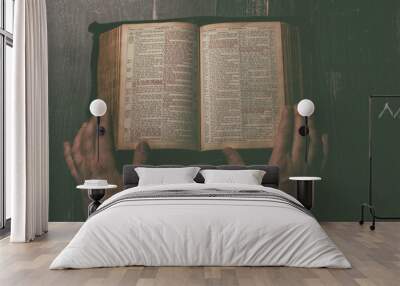 Prayer, man hands over an old open book Holy Bible, wooden desk background. Wall mural