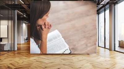 young woman pray with bible relationship with God at home Wall mural