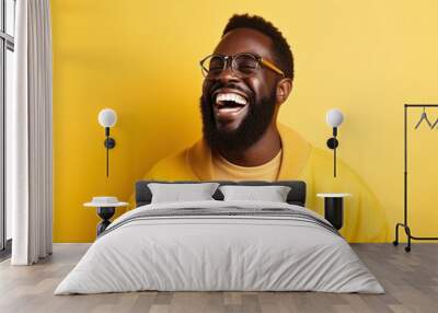 Portrait of a smiling fictional black model with a beard and glasses. Isolated on a bright yellow colored background. Generative AI. Wall mural