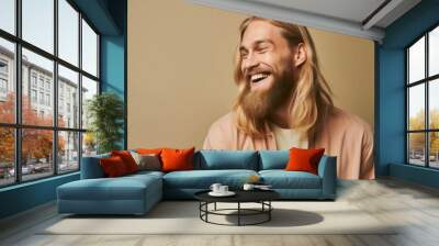 Studio portrait of a fictional handsome nordic man with long blonde hair and a beard laughing candidly. Isolated on a plain background. Generative AI illustration. Wall mural