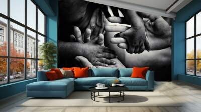 Helping children. Volunteer. Adult holding smal hands of little african child. Support and help to coutries of third world. Unity in diversity. Children suffer of poverty due to bad economy Wall mural