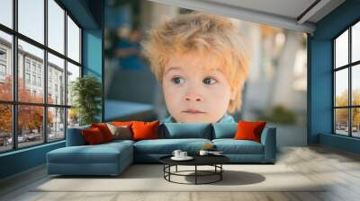 Scared surprised child, boy with big eyes from fear or surprise. Funny face of emotional kid. Clever boy portrait, child face from new information, good or strange news. Fear or fright on child face Wall mural