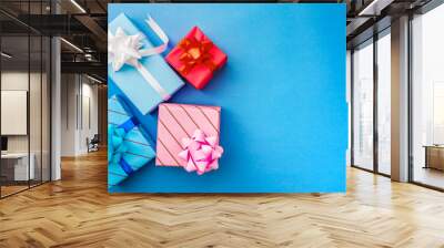 Wrapped gifts with on blue background with copy space for text Wall mural