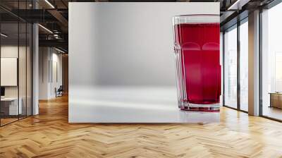 Fresh pomegranate juice, a side view of a glass filled with fresh pomegranate juice, the deep red color vibrant against a clean white background  Wall mural