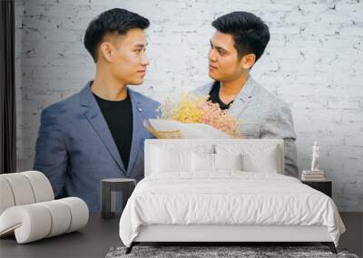 Gay couple holding a bouquet of flowers, ready to give to his partner for special occasions or wedding proposal. Asian homosexual men together Wall mural