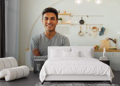 Portrait of smart smiling Caucasian man standing with arms folded at home posing for photos with copy space. Attractive middle age female freelancer looking at camera Wall mural