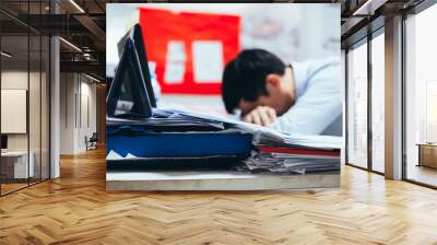 Stressful and frustrated young Asian business office worker having overwork problem crisis with tons of paperwork load. Wall mural