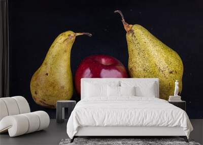 One apple and two pears on darc background. Homegrown organic fruits. Wall mural