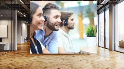 Attractive positive young businesspeople and colleagues in a call center office. Wall mural