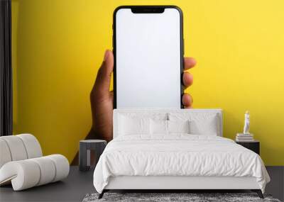 black woman's hand showing big smartphone, white screen empty copy space for advertising banner isolated on yellow background, display mock up Wall mural