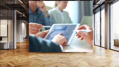 Business person analyzing financial statistics displayed on the tablet screen Wall mural