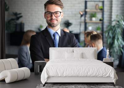 Businessman with colleagues in the background in office. Wall mural