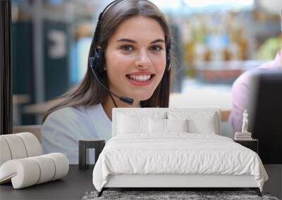 Female customer support operator with headset and smiling. Wall mural